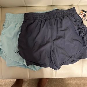 2 pairs Avia running shorts. NWT